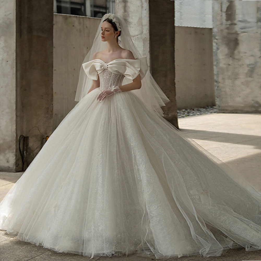 Off The Shoulder Sweetheart Neck Shiny Beading Pearls Bow Tulle Lace Bow Ball Gown Wedding Dresses With 100cm Chapel Train